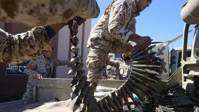 Fighters loyal to the Libyan Government of National Accord prepare their ammunition before heading to the frontline for battles against forces of Khalifa Haftar. Picture: AFP