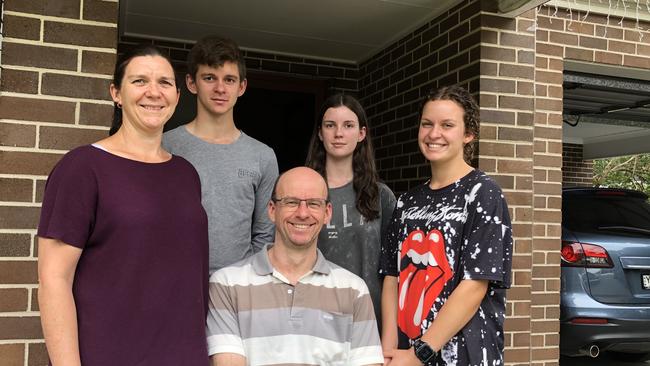 Nicole and Chris Campbell-Rogers with their children Peter, Eleanor and Erica at their Northmead home after the Whitehaven Rd fire.