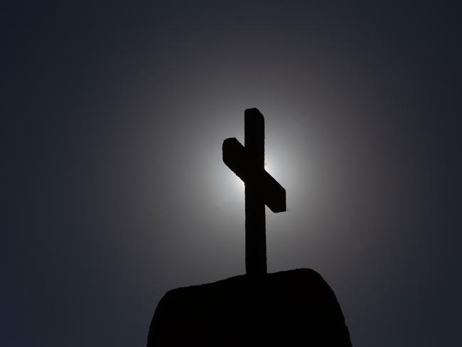 Picture of a cross taken in Punta de Tralca, west of Santiago, on July 30, 2018 as Chile's Episcopal Conference holds an extraordinary meeting to analyze the roots of the current crisis that the Catholic Church is experiencing in the country, burdened by the scandals of sexual abuse and cover-up, and how to overcome it. Chile is investigating more than 150 members of the country's embattled Catholic Church -- both clergymen and lay people -- for perpetrating or concealing the sexual abuse of children and adults, prosecutors said last week. / AFP PHOTO / CLAUDIO REYES