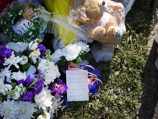 Floral tributes and messages were left for the family of three children who were killed in a house fire at Lalor Park. Picture: Richard Dobson