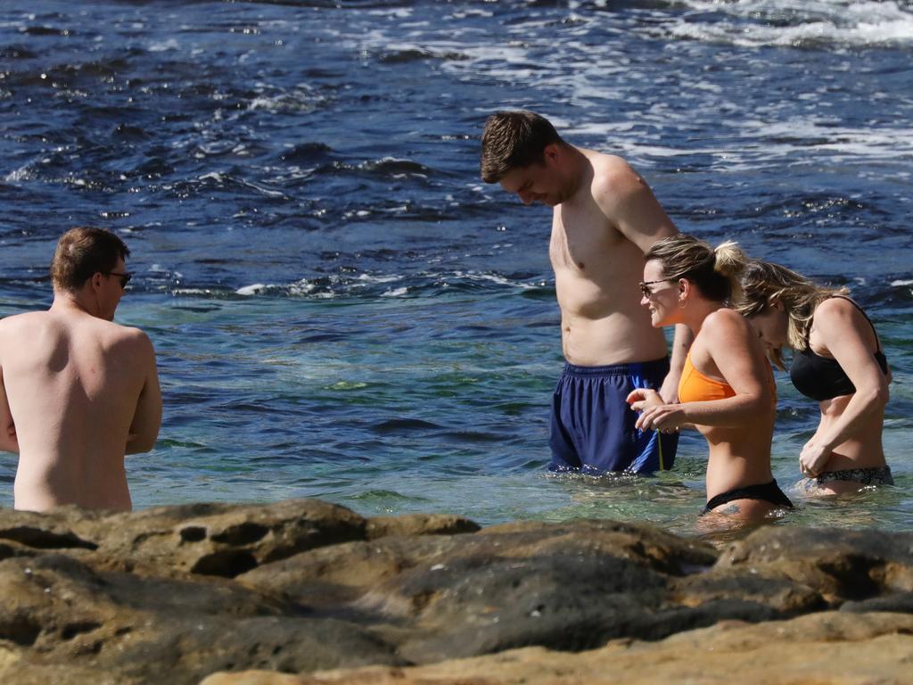 Groups of more than two were spotted in the water at Manly beach this morning. Picture: Matrix