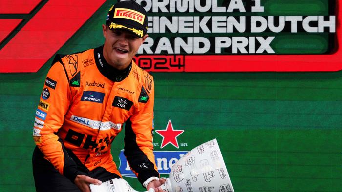 Winner McLaren's British driver Lando Norris celebrates during the podium ceremony after the Formula One Dutch Grand Prix at The Circuit Zandvoort, western Netherlands, on August 25, 2024. (Photo by SIMON WOHLFAHRT / AFP)