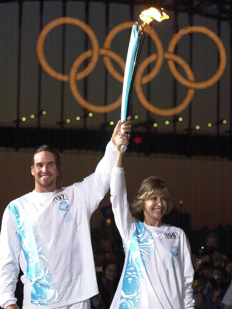 Tennis champion Pat Rafter with Newton-John at the Olympic Torch Relay in 2000.