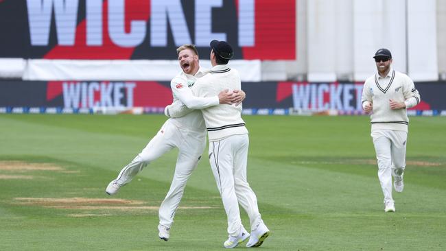 Glenn Phillips (left) celebrates with Matt Henry after dismissing Mitch Marsh in the second innings. (Photo by Hagen Hopkins/Getty Images)