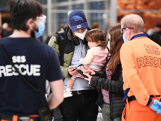 Rhys Roscoe holds his daughter Mia 20 months who arrived with his wife Safia to live in Adelaide with the last of the Melbourne passengers arriving at Adelaide Airport before the 6pm lockdown Wednesday May,26,2021.Picture Mark Brake