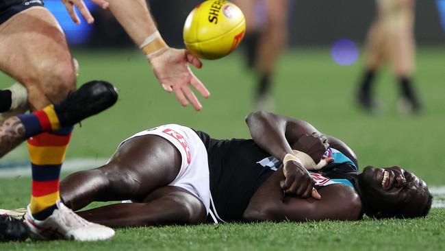 Aliir Aliir of the Power down after a collision with Lachie Jones (Photo by Sarah Reed/AFL Photos via Getty Images)