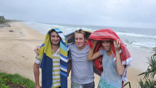 Michael Twohill, Oscar Dougherty and Louise Thomas of Newcastle optimistically head to the beach at Coolum.