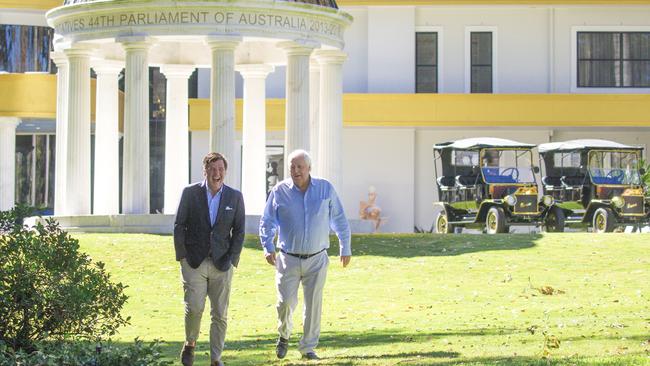 American journalist Tucker Carlson and mining magnate Clive Palmer at his Fig Tree Pocket property in June. In the background is the original home that’s been refurbished, along with a memorial to his time in federal parliament. Picture: NewsWire/Glenn Campbell.