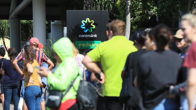 Lines of people wait at Southport Centrelink. Picture: Adam Head