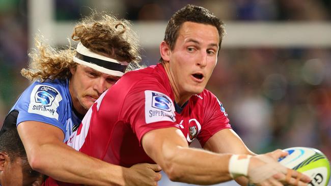 PERTH, AUSTRALIA - JULY 05: Mike Harris of the Reds looks to offload the ball during the round 18 Super Rugby match between the Western Force and the Queensland Reds at nib Stadium on July 5, 2014 in Perth, Australia. (Photo by Paul Kane/Getty Images)