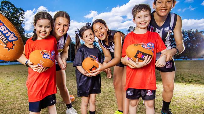 AFL Auskick kids for story about AFL junior participation numbers.Sherwood Magpies juniors Sophie David, 16, Leilani Hockley, 12 and Eli Jessen, 12 with Auskick kids Abigail Keane, 5, Harper Hopkins, 5 and Matthew Keane, 7.Picture: Nigel Hallett*****Chris Keane (DAD) 0414354242*****