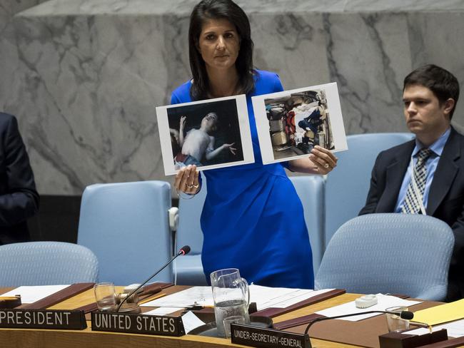 U.S. Ambassador to the United Nations Nikki Haley holds up photos of victims of the Syrian chemical attack. Pictur: Getty Images/AFP