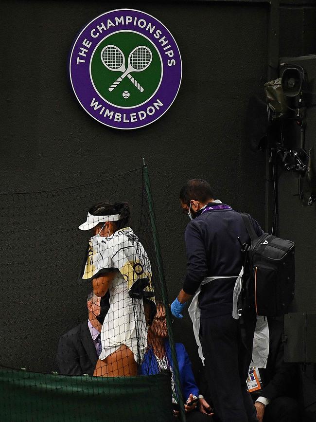 Britain's Emma Raducanu (L) takes a medical time out during the match against Australia's Ajla Tomljanovic.