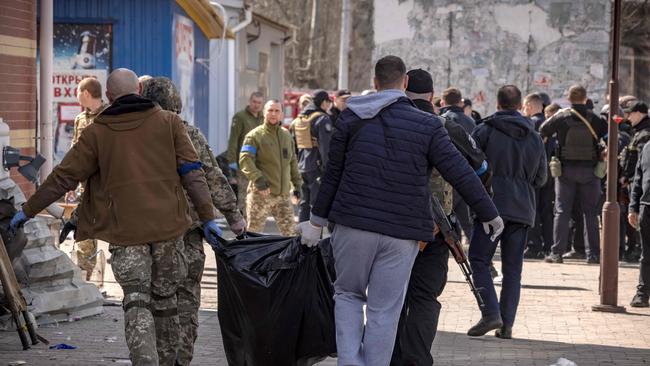 Bodies are cleared from the train station in Kramatorsk on Friday. Picture: AFP