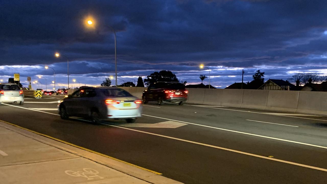 Two vehicles at the end of the evening peak cross the chevrons to change lane. Picture: Benedict Brook