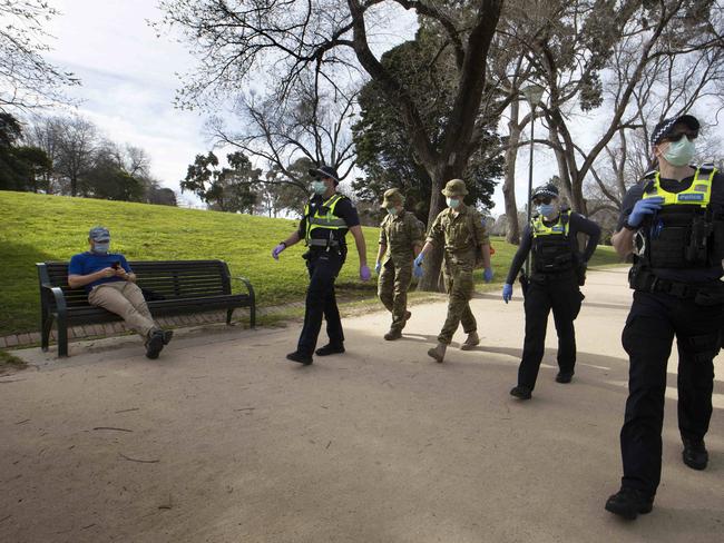 Police officers and army personnel patrol the Tan Track. Picture: David Geraghty