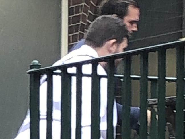 James Mark Parisi-Yacoub (left), 26, of Frenchs Forest, enters Manly Court House on Wednesday. Picture: Jim O'Rourke