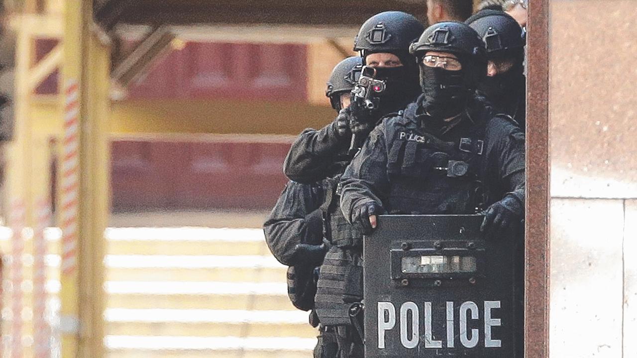 Armed police, including Tactical Operations Unit officer Ben Besant, outside the Lindt Cafe in 2014. Picture: Mark Metcalfe/Getty Images