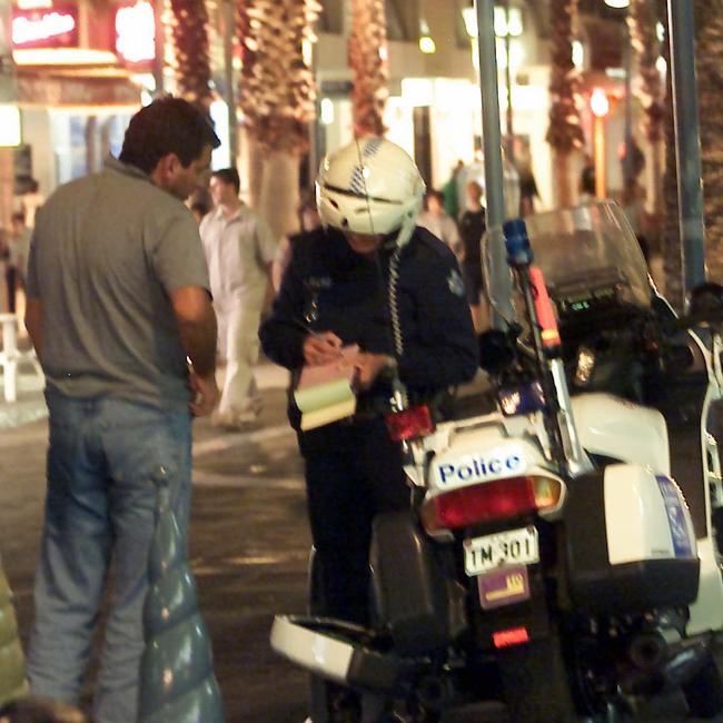 2002 Motorcycle police officer writing a ticket.