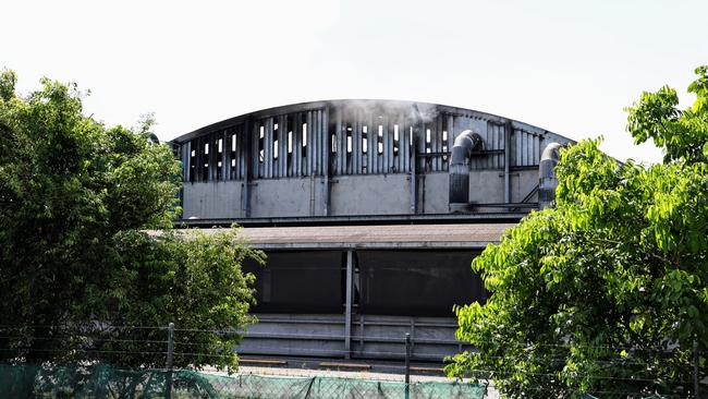 A large structure fire at the Cairns Regional Council's waste transfer station at Portsmith was still burning on Friday morning, 14 hours after the blaze began just before 8pm on Thursday. Smoke could be seen billowing out of the rubbish tip's main storage facility, with the roof of the steel structure completely collapsed due to the ferocity of the fire. Picture: Brendan Radke