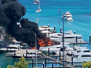 A luxury superyacht docked at a marina in the Whitsundays has exploded into a ball of flames, spewing enormous plumes of smoke into the air and blanketing nearby vessels. Picture: Facebook.