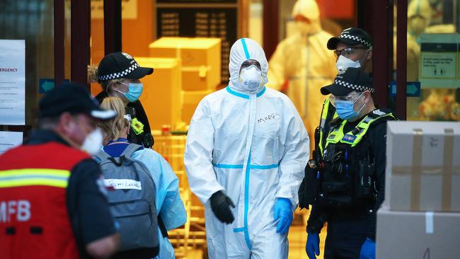 Emergency services pack up outside the tower at 159 Melrose Street, North Melbourne, where no residents tested positive for the coronavirus. Picture: Ian Currie