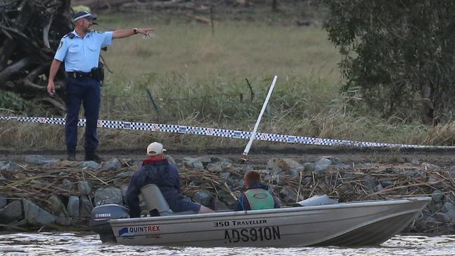 Matt Grinham and son Thomas Grinham 15 use a depth sounder to locate the car in the river. Picture: Glenn Hampson