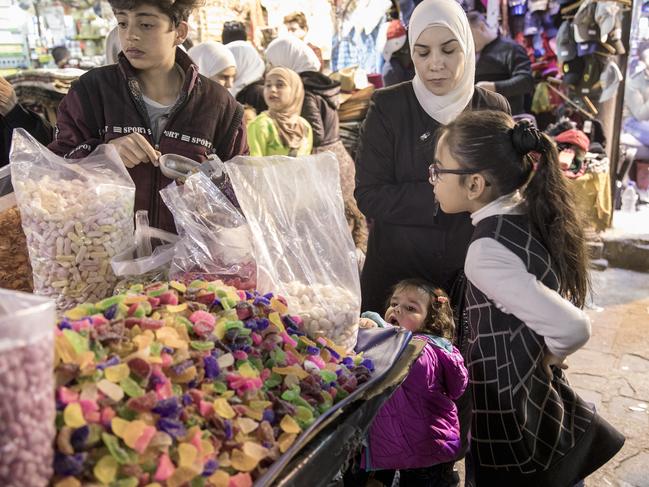 Children at a candy shop in Al-Hamidiyah Souq, Damascus, Syria. Picture: Ella Pellegrini