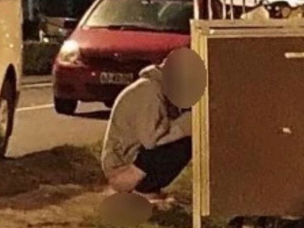 A man photographed squatting behind a row of rubbish bins at East Esplanade Park, Manly. Picture: Supplied