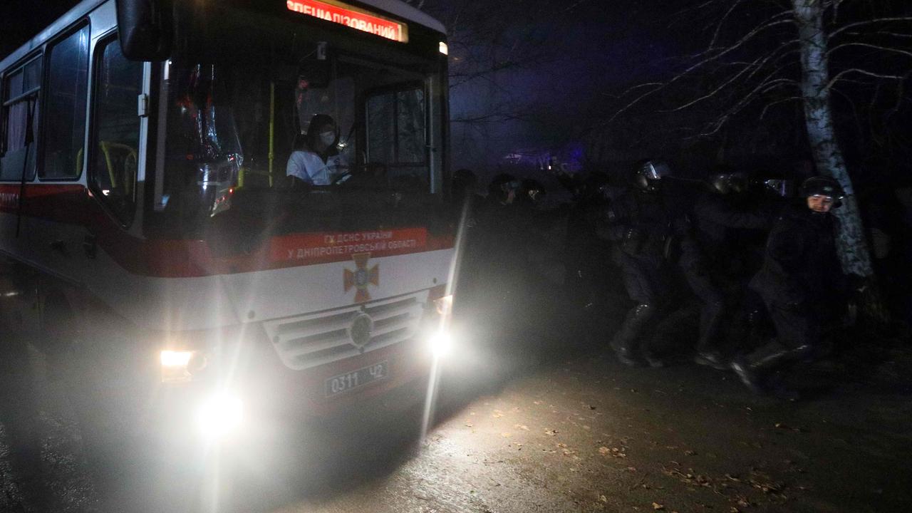 Buses carrying evacuees from coronavirus-hit China arrived at a medical facility in Ukraine overnight. (Photo by STR / AFP)