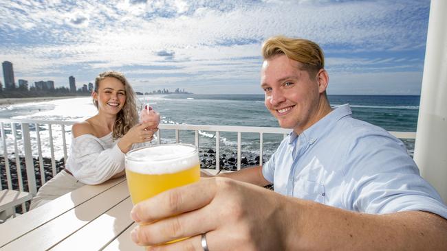 Bars and restaurants are bracing for the biggest Friyay session in Gold Coast history as restrictions involving bar service lift tomorrow in time for knock-off drinks. Emma-Lee Hesford and Joel Martin enjoying a drink at the Burleigh Pavilion. Picture: Jerad Williams