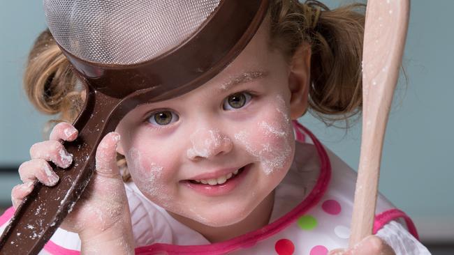 Millie Esler, 4, helps her mum Natalie in the kitchen. Picture: Jay Town