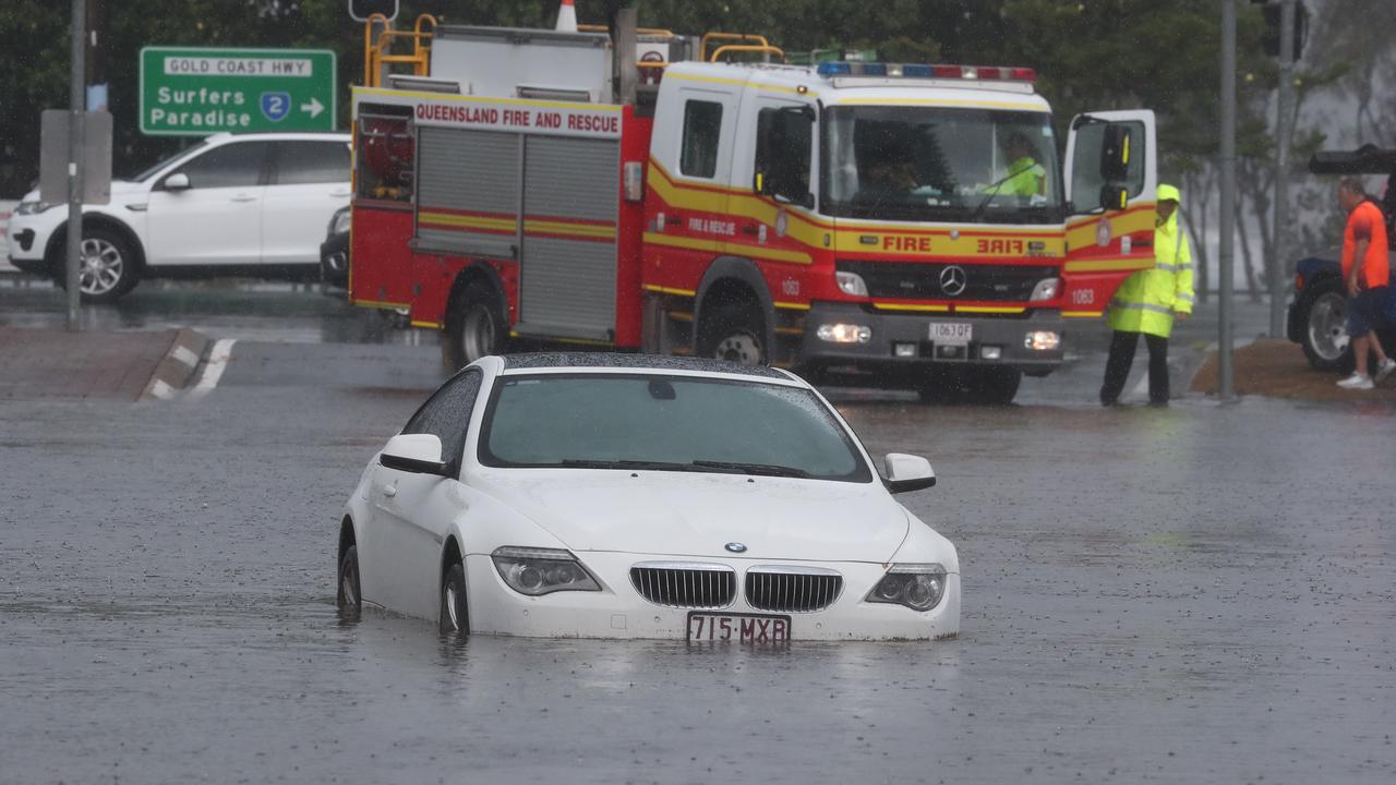 A car is flooded on Queen St in Southport after a storm lashes the Gold Coast. Photograph : Jason O’Brien