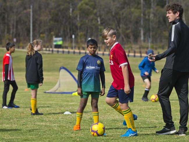 Viren Sevakumar (left) and Tom Pezet under instruction from coach Mirko Crociati during the Brisbane Roar Academy Highfields FC July holiday camp, Sunday, July 5, 2020. Picture: Kevin Farmer