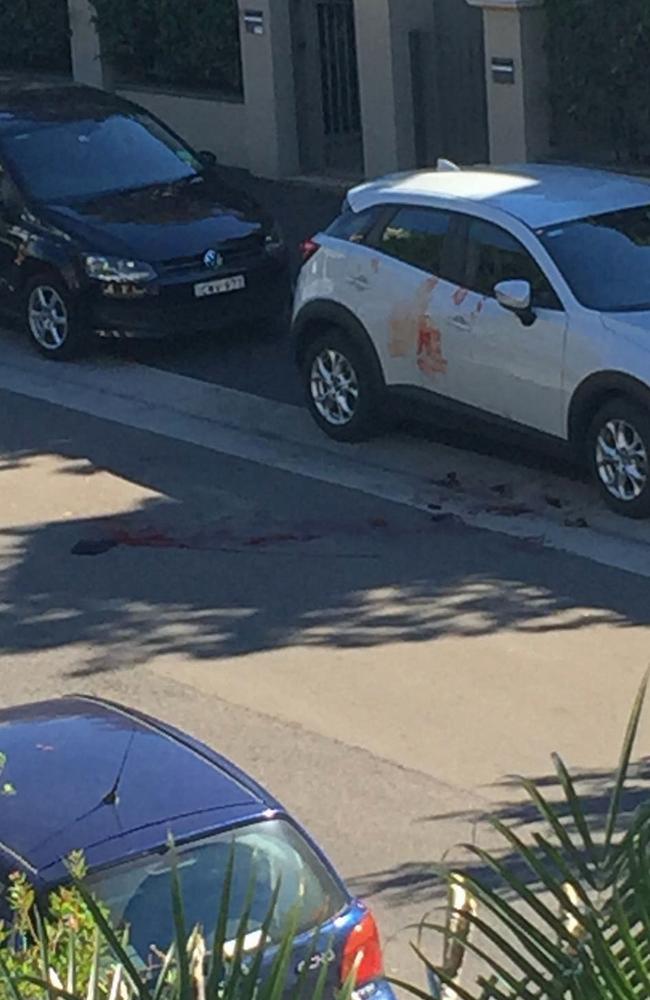 Blood is seen on the road and on a car near where a body was found at Forest Lodge. Picture: Supplied