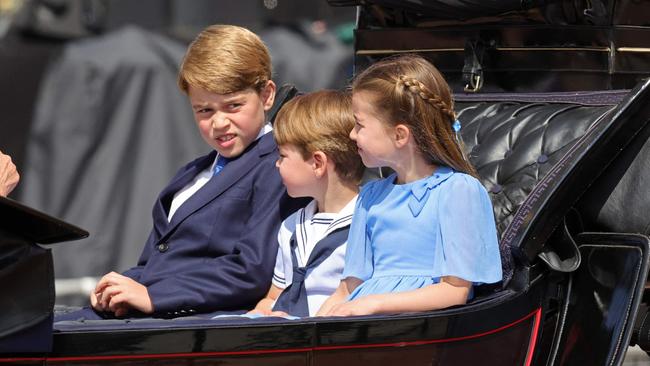 Prince George, left, Prince Louis and Princess Charlotte ride in a carriage during the Queen's Birthday Parade in London on Thursday night. Picture: AFP