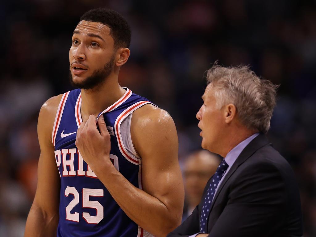 Ben Simmons listens to instructions from 76ers coach Brett Brown.