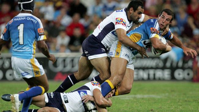 GC's Anthony Laffranchi looks to pass as he is tackled high by Tonie Carroll and low by Shane Perry (AAP Image/Colin Whelan/Action Photographics)