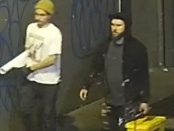 Detectives have released CCTV of two men who they believe may be able to assist with inquiries into offensive posters that were displayed in Manly this morning.