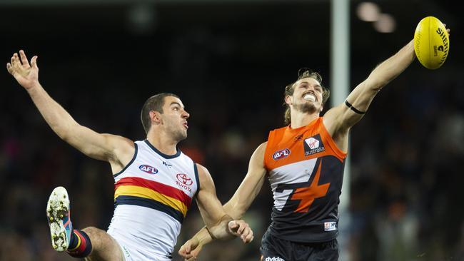 Taylor Walker competes with Harry Himmelberg of the Giants. Picture: AAP Image/Rohan Thomson