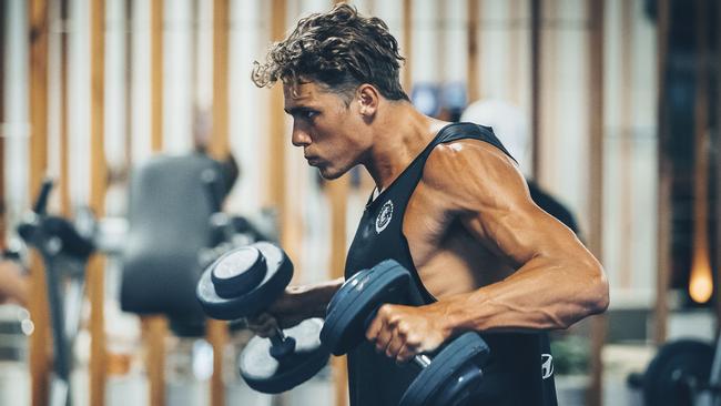 Curnow pumps iron in the gym during the Blues’ pre-season camp on the Sunshine Coast. Picture: Ben Vos