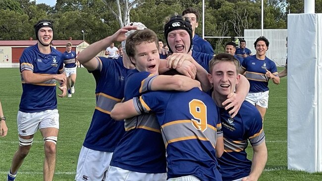 Mac Kelley hugs Archie Wilson after one of his tries this season.