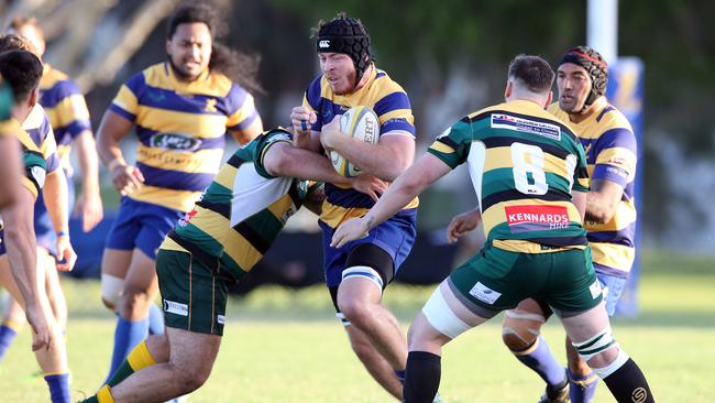 Eagles lock Angus Blake is tackled by Surfers No.8 Jono Makris (right). Picture: Richard Gosling