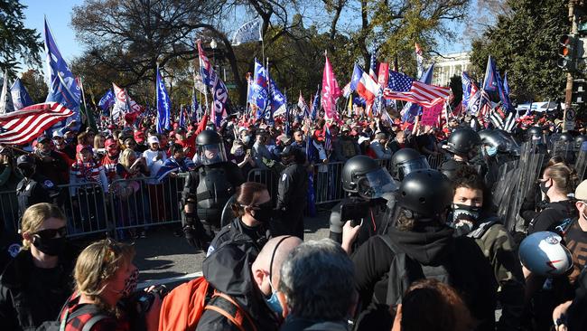 Police stand guard between counter-protester and supporters of US President Donald Trump during rally in Washington, DC. Picture: AFP