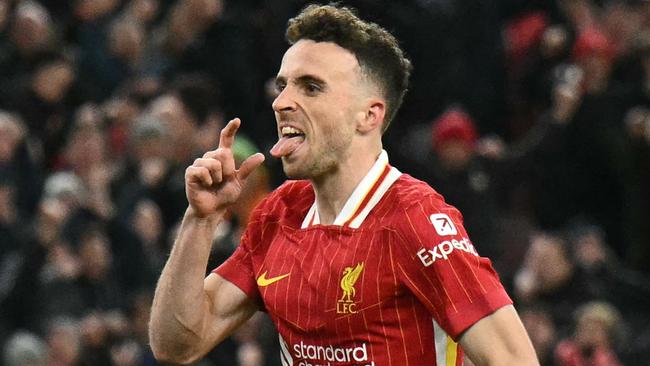 Liverpool's Portuguese striker #20 Diogo Jota celebrates after scoring their second goal during the English Premier League football match between Liverpool and Fulham at Anfield in Liverpool, north west England on December 14, 2024. (Photo by Oli SCARFF / AFP) / RESTRICTED TO EDITORIAL USE. No use with unauthorized audio, video, data, fixture lists, club/league logos or 'live' services. Online in-match use limited to 120 images. An additional 40 images may be used in extra time. No video emulation. Social media in-match use limited to 120 images. An additional 40 images may be used in extra time. No use in betting publications, games or single club/league/player publications. /