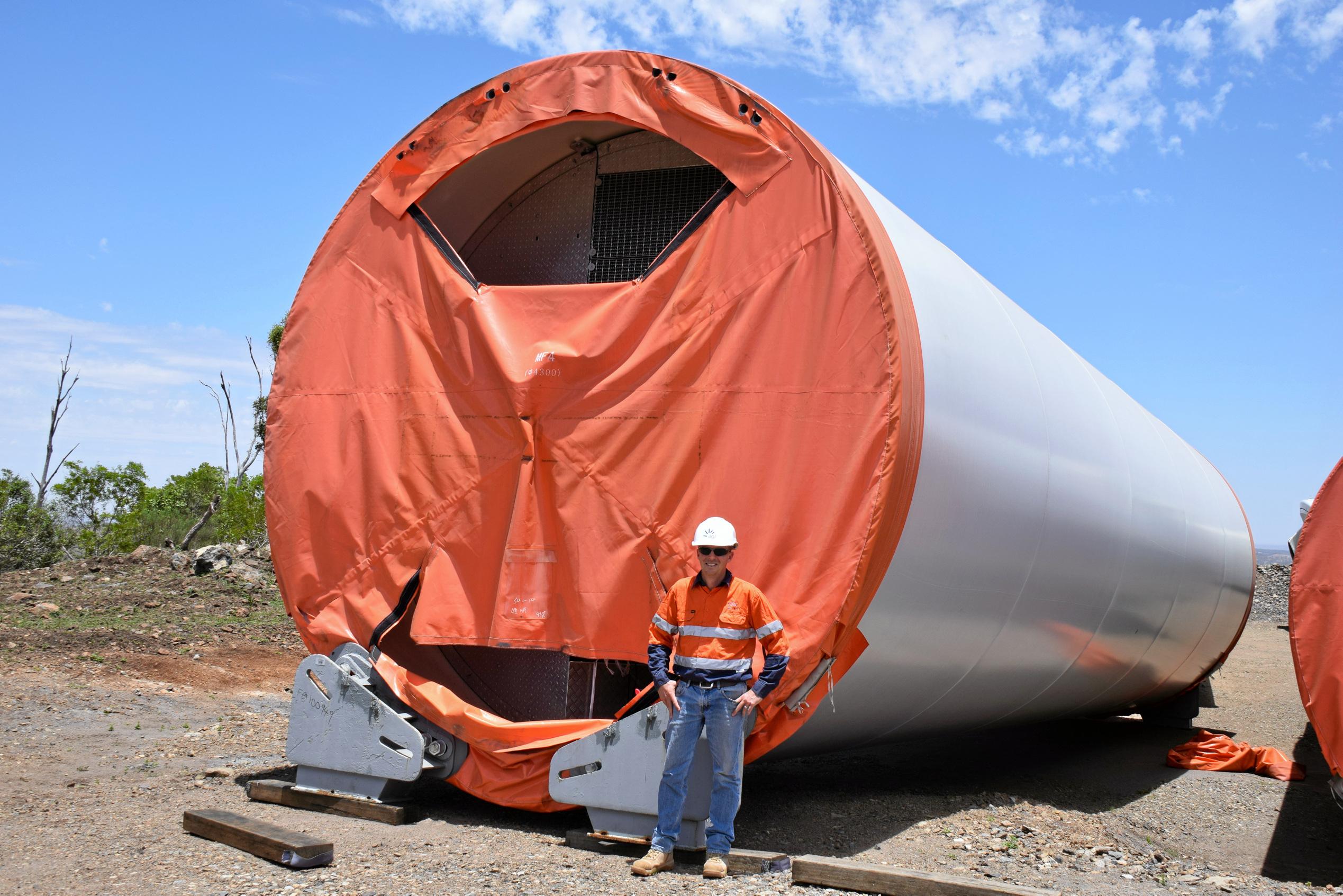 AGL's Michael Yeo next to one of the 30 metre tower sections of one of the wind turbines. Picture: Matt Collins