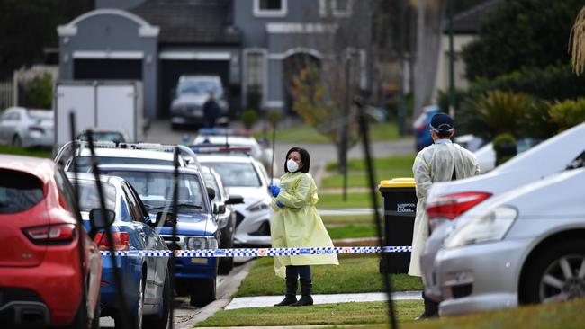 SYDNEY, AUSTRALIA – NewsWire Photos JULY, 19, 2021: A woman wearing PPE as NSW Police establish a crime scene at Thursday Place Green Valley in Sydney. Picture: NCA NewsWire/Joel Carrett