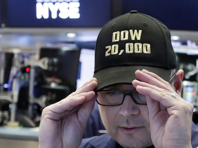 Specialist Mario Picone adjusts his Dow 20,000 cap as he works on the floor of the New York Stock Exchange, Wednesday, Jan. 25, 2017. The Dow Jones industrial average is trading over 20,000 points for the first time, the latest milestone in a record-setting drive for the stock market. The market has been marching steadily higher since bottoming out in March 2009 in the aftermath of the financial crisis. (AP Photo/Richard Drew)