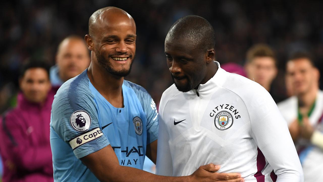 Vincent Kompany of Manchester City embraces Yaya Toure.