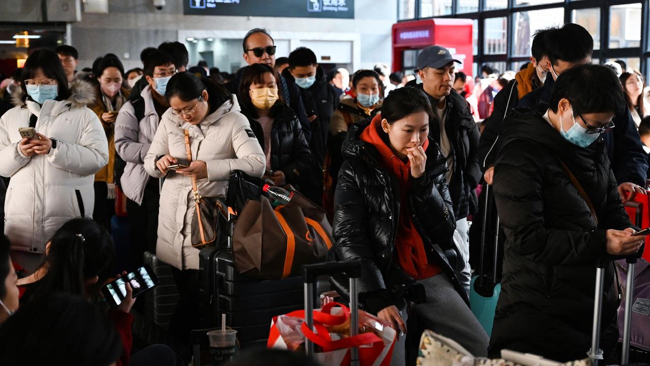 People wait to board a train at Beijing West Railway Station in Beijing ahead of the Lunar New Year of the Dragon. Picture: GREG BAKER / AFP